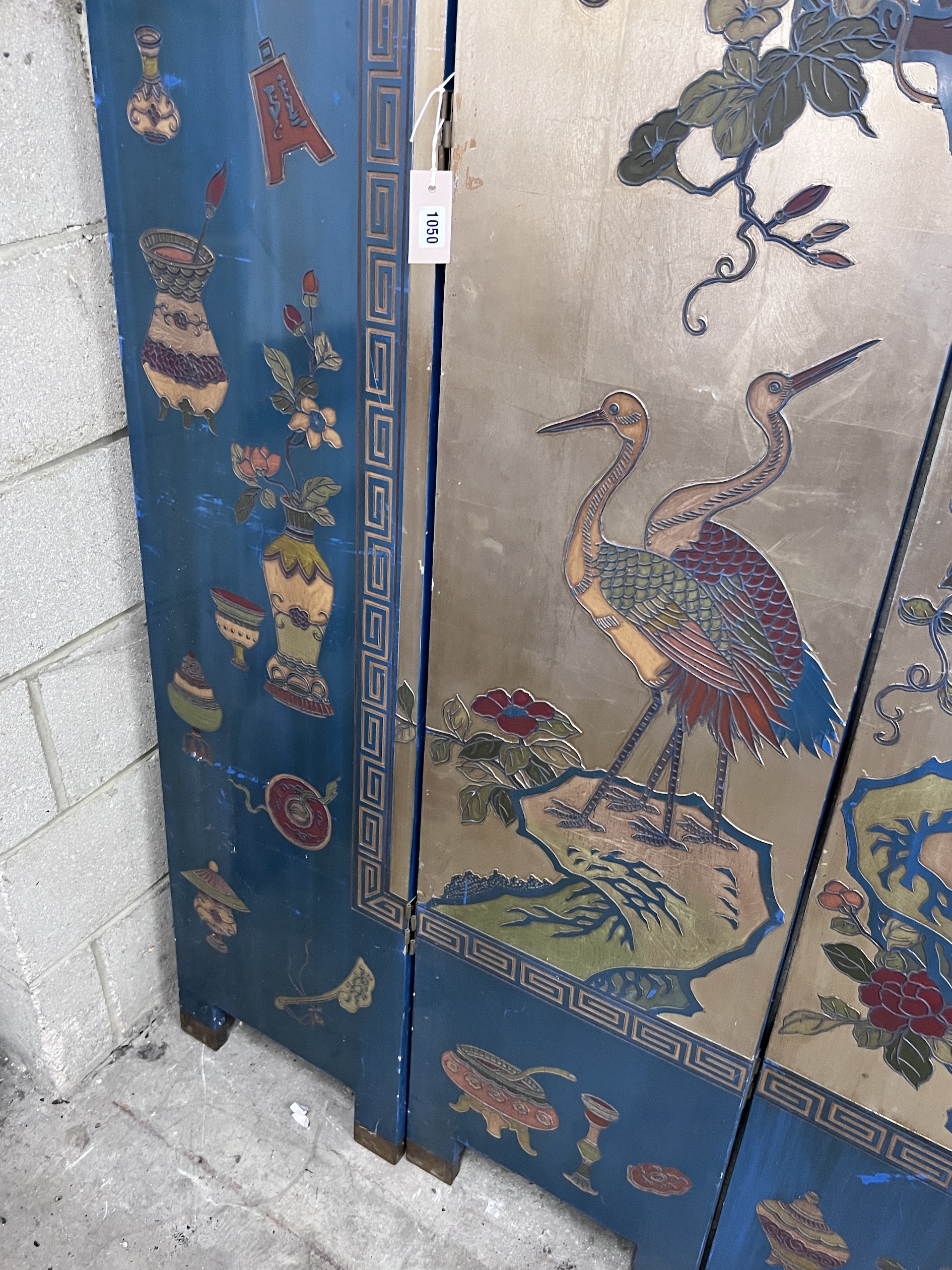 A Chinese lacquered eight fold screen decorated with exotic birds among flowering trees, each panel width 40cm, height 244cm (no fixing clips)